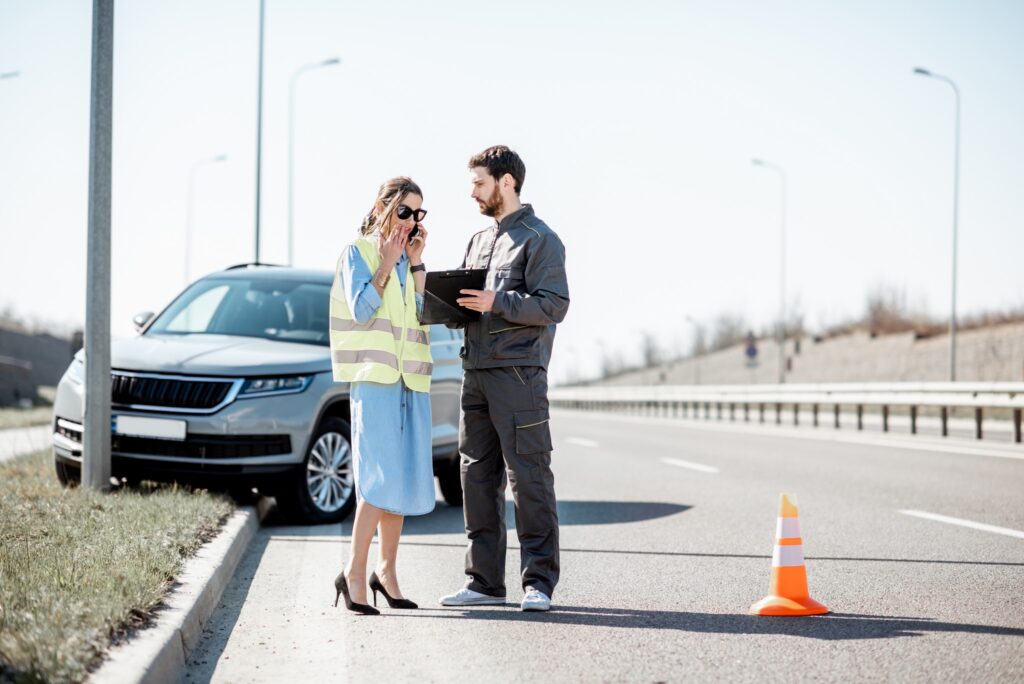 Woman With Road Worker During The Road Accident